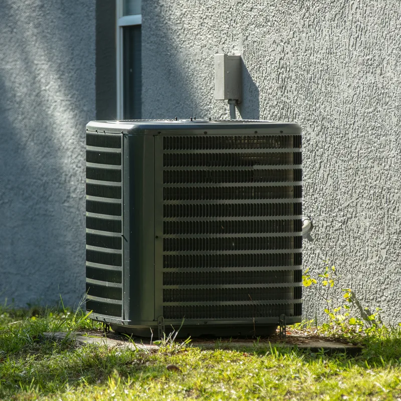 A residential condenser unit beside a Bakersfield home, freshly serviced