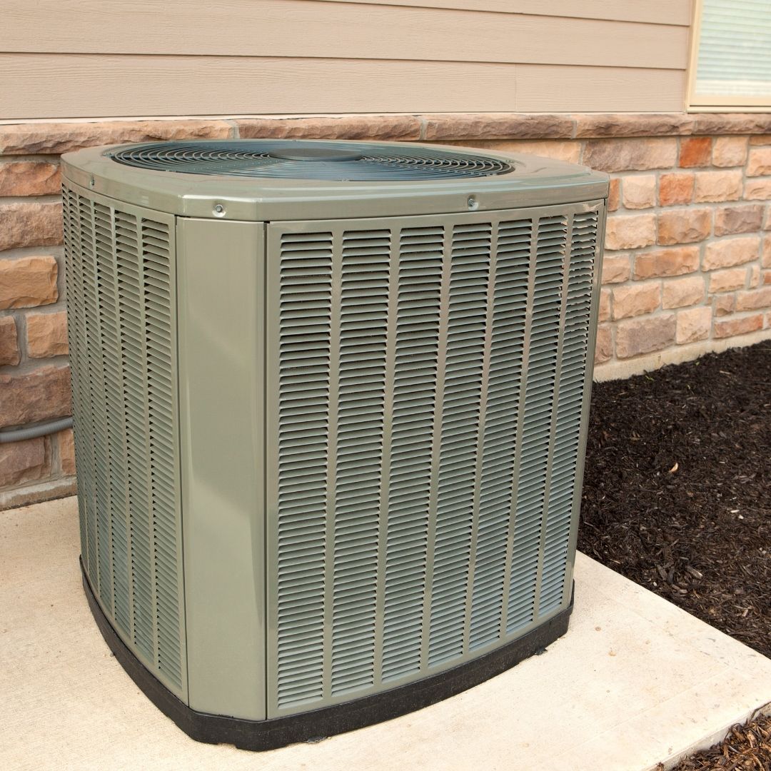 man cleaning a filter on a AC unit