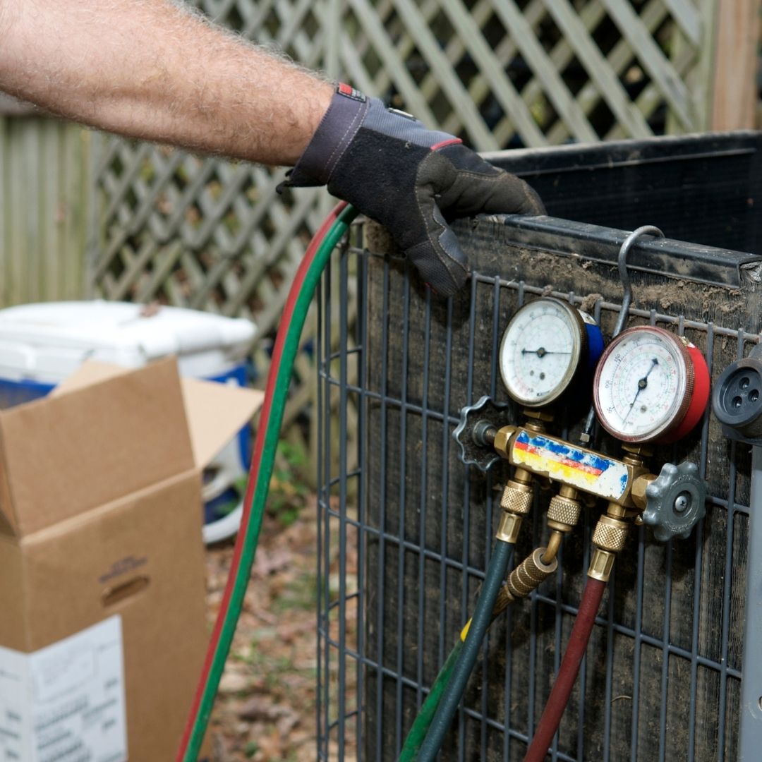 Man looking at a vent and checking a warranty