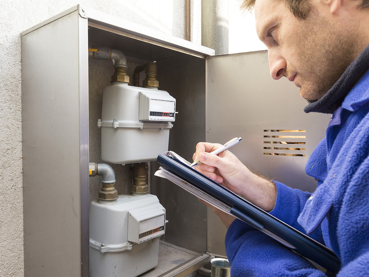 Image of a plumber at work on a home. 