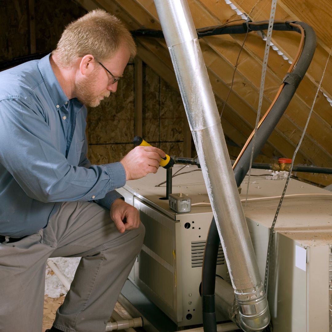 man looking at furnace